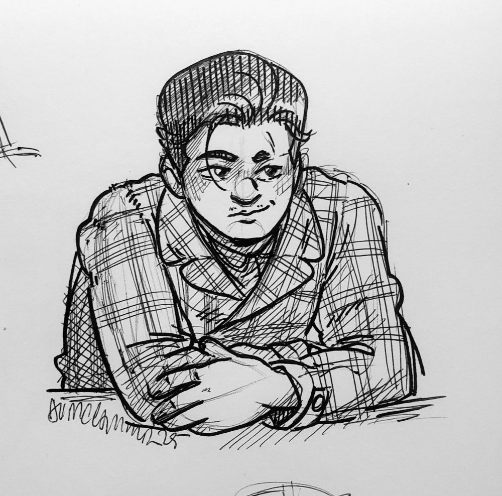 Nicolasia "Nicky" Flores, a latinx butch with a dark pompadour, leans against an unseen countertop with her arms crossed. She wears a cozy plaid coat that just barely shows her shirt underneath, her thin gold necklace awkwardly tucked into the collar. She looks off into the distance at something with an amused expression on her face, mouth pulled into a soft smile.