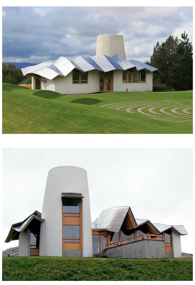 Picture of Frank Gehry’s building for Maggie’s Centre in Dundee. It has a folded roof that almost looks like it’s been crunched, and a smooth turret like structure that rises up above everything else and offers views into Central Scotland. 