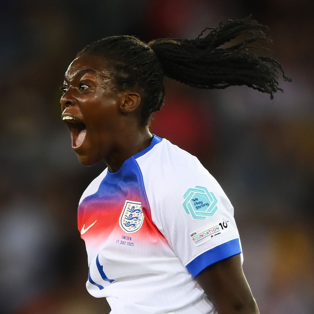 A young woman wearing an England Football Team shirt screams with delight after scoring an important goal in the 2025 European Football Championships.
