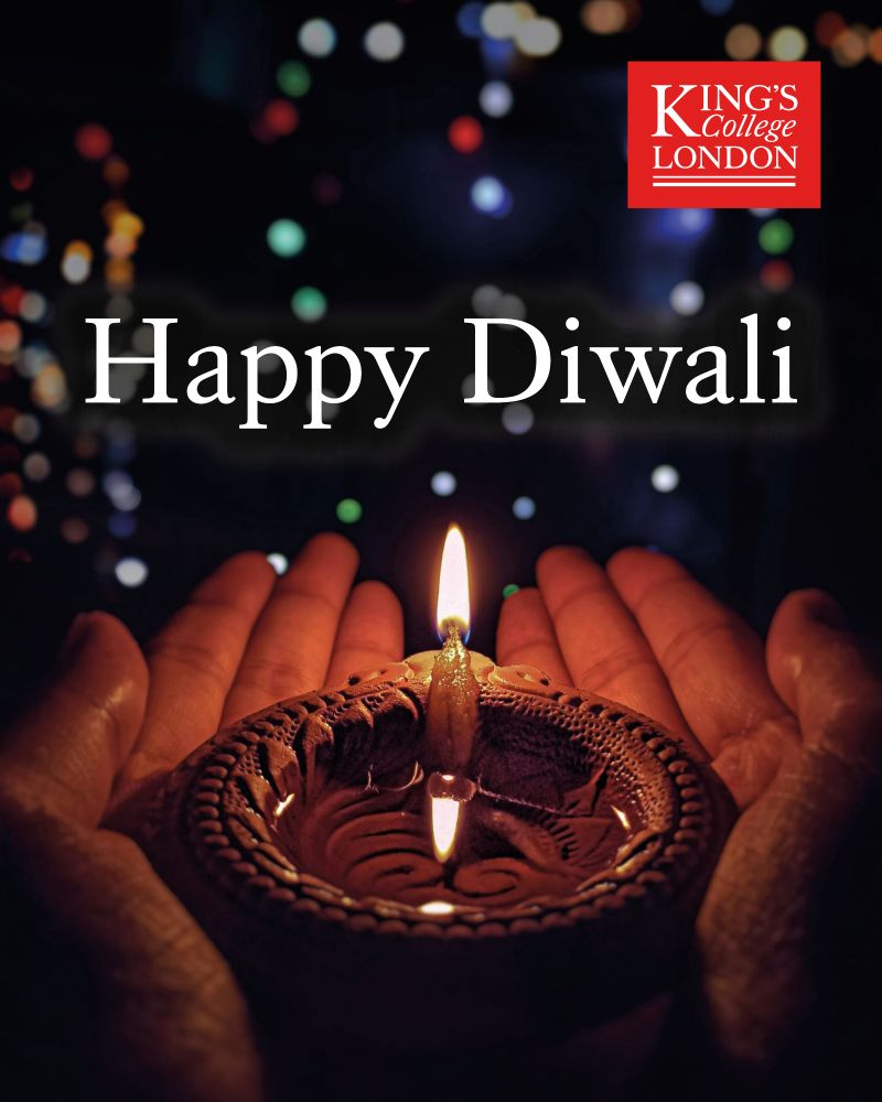 A pair of hands holds a small decorative dish containing a lit candle. A caption on the image reads 'Happy Diwali'.
