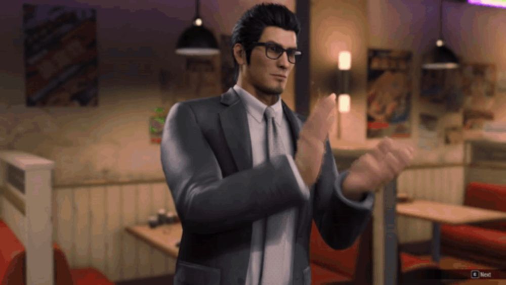 a man in a suit applauds in a video game