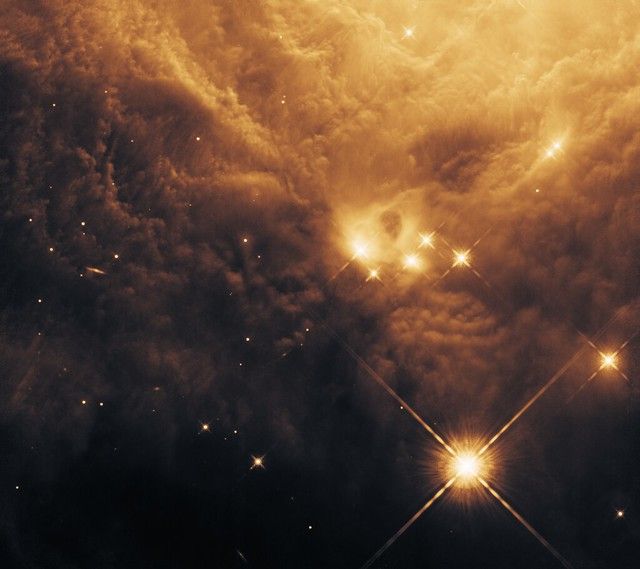 There are some places we can never go; even if we could, it would never feel like we were there. They are safe from our corruption, but by the gift of light we are able to glimpse them.

This is a small portion of NGC 2023, a piece of the sky I find profoundly beautiful. I have colorized a single near-infrared image that would otherwise be grayscale. 

NICMOS Imaging of Protostars in the Orion A Cloud: The Role of Environment in Star Formation

All channels: WFC3/IR F160W

North is 64.50° counter-clockwise from up.