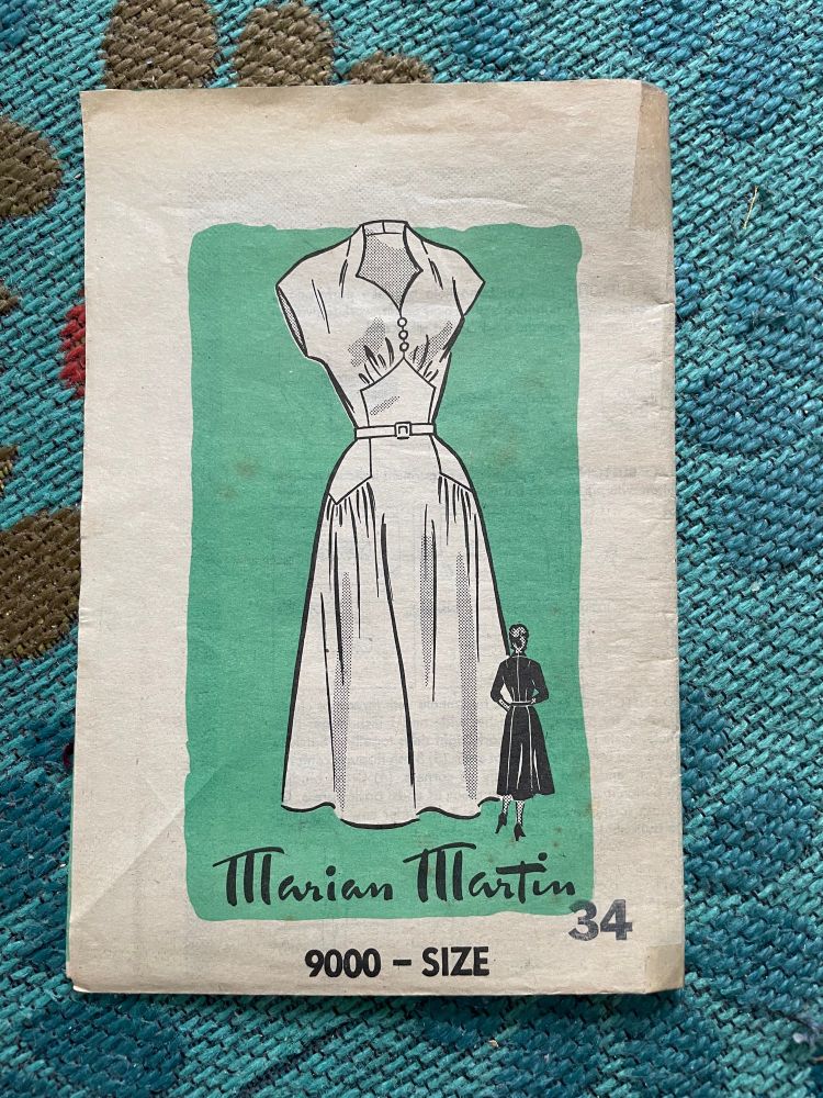 Booklet for a mid-1950’s style short-sleeved dress with a stand-up mock halter neck collar, interesting lines where one pentagonal panel on the stomach follows into a pentagonal panel on each hip, with gathers at the bosom and skirt at the top and bottom of these panels respectively.