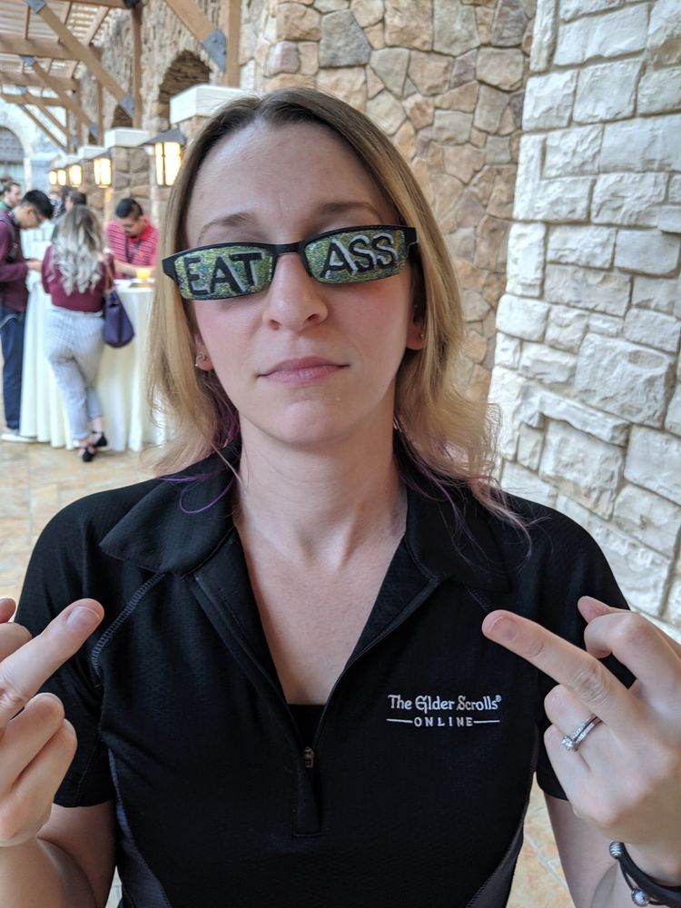 ZOS Gina Bruno flipping off the camera while wearing EAT ASS sunglasses