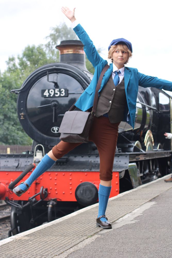 andy as clive posing with a steam train (they are in a starfish pose balancing on one leg. yes they did shortly fall over after this) 