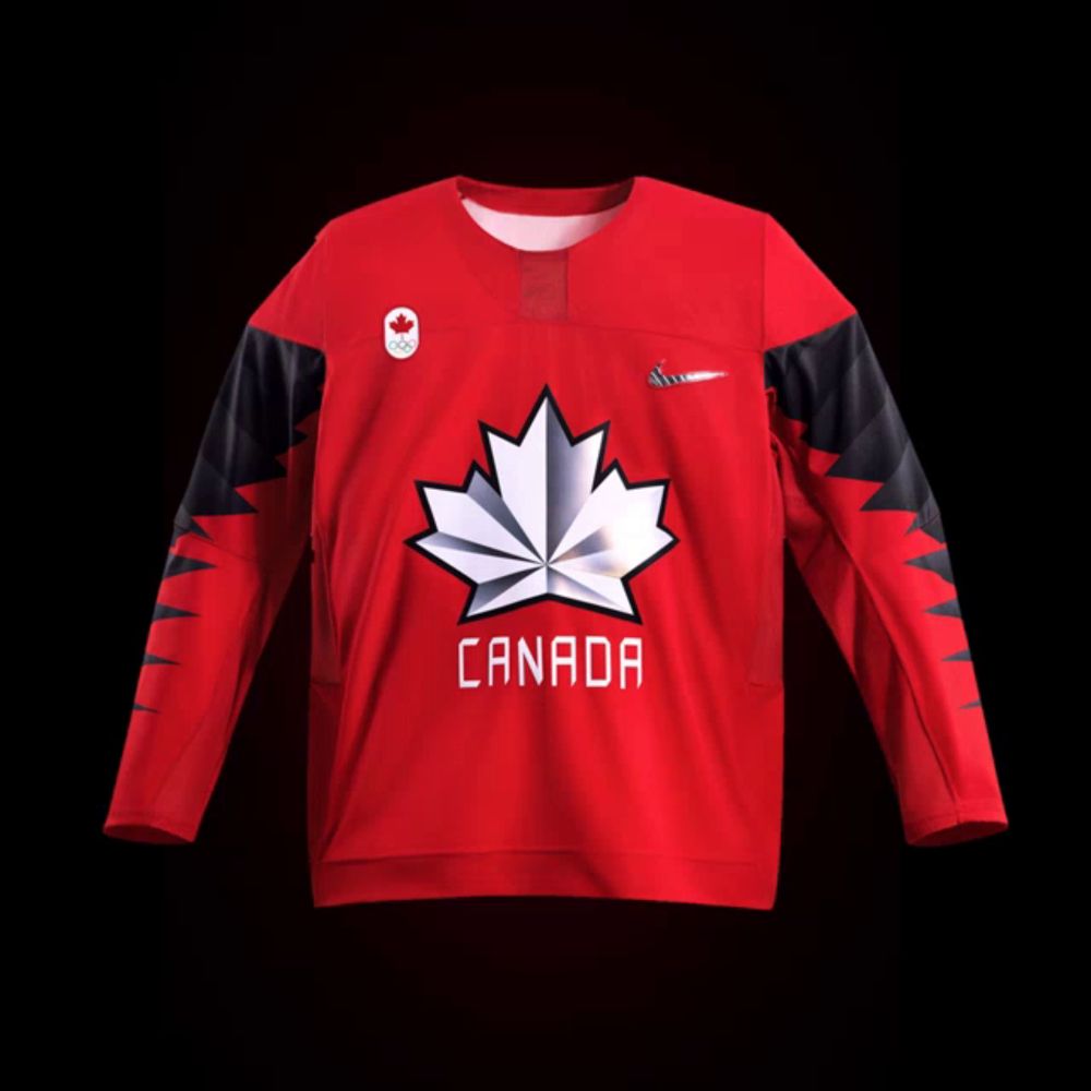 a red jersey with a maple leaf and the word canada on the front