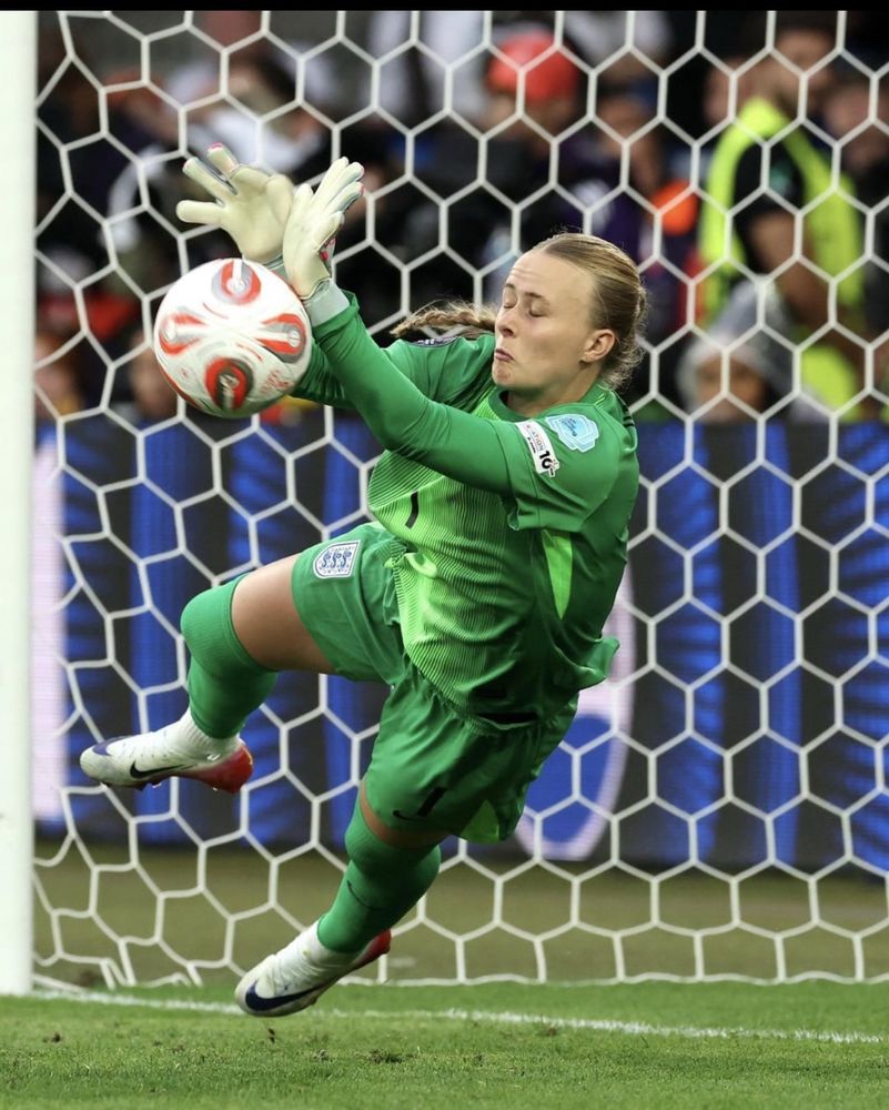 Image: Hannah Hampton England goal keeper wearing a green GK kit, pushing ball away in an immense save.