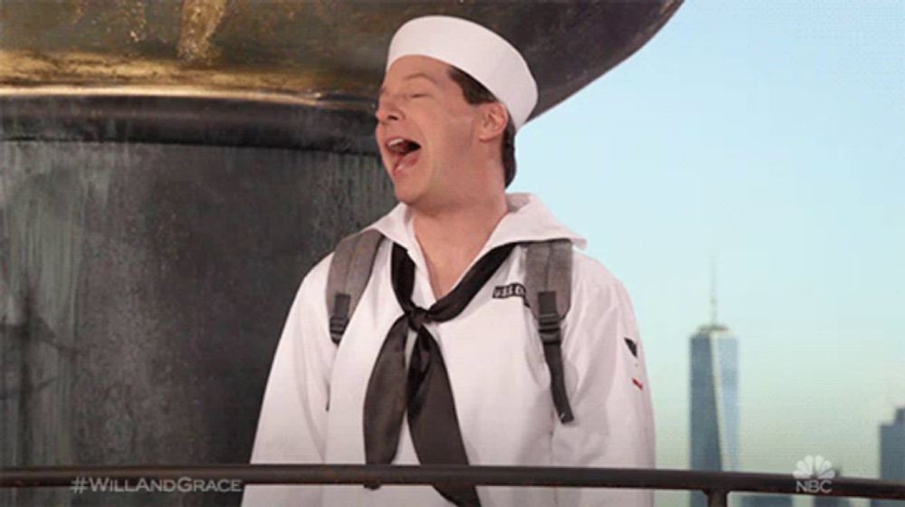 a man dressed as a sailor singing a song with #willandgrace written on the bottom