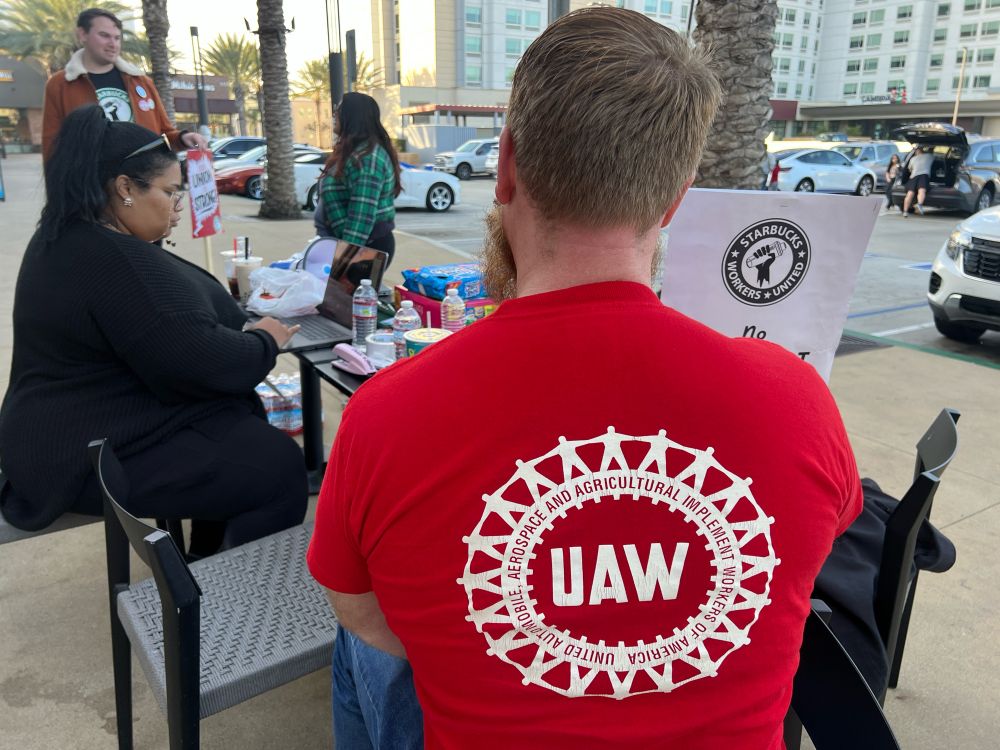 little candid of a uaw worker at the sbwu picket table