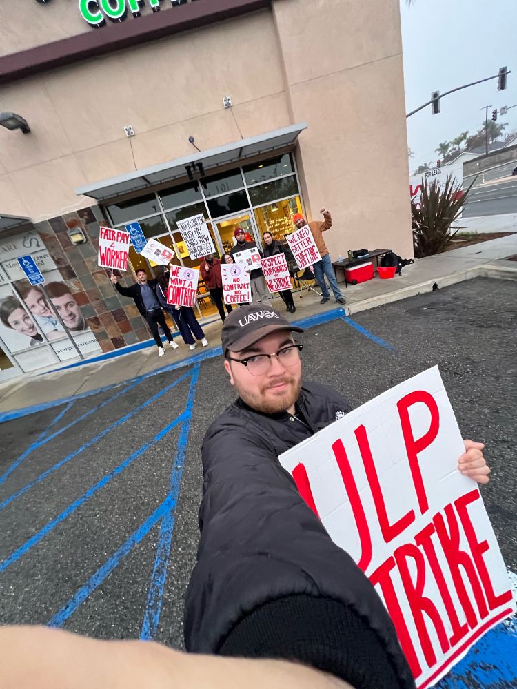 me taking a wide angle selfie of the picket holding an sbwu « ulp strike » sign