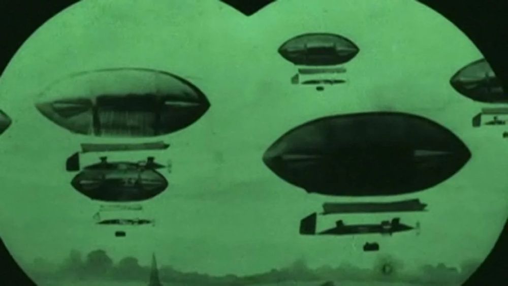 An image from The Airship Destroyer, a point of view shot through binoculars showing a fleet of blimps