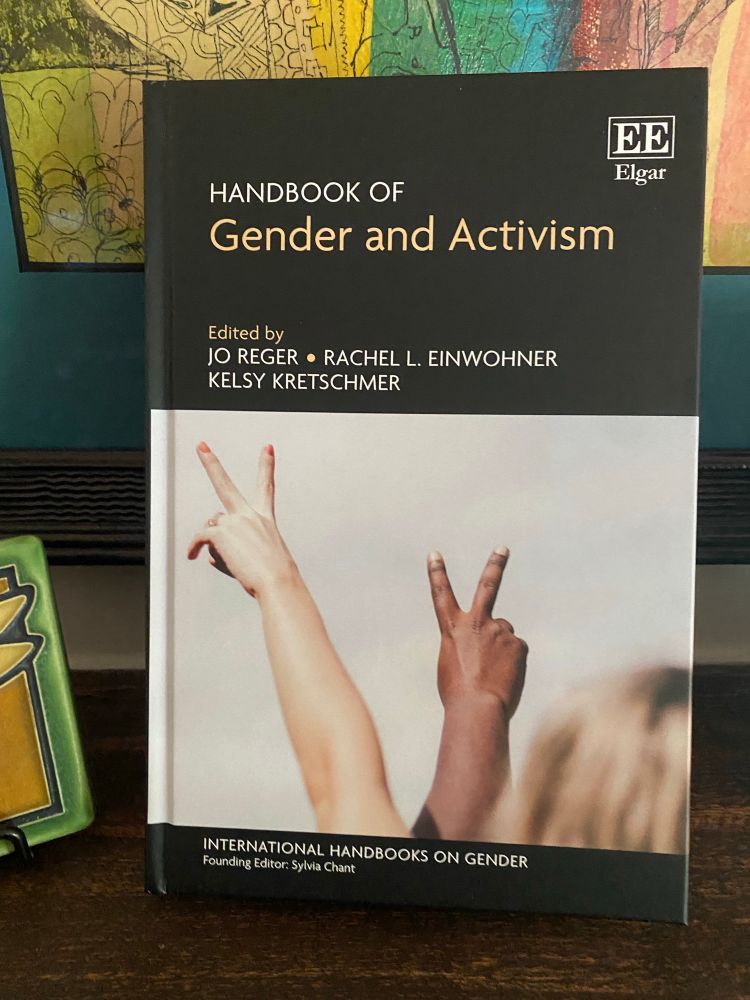 Cover show two hands raised in peace symbols with their fingers.  