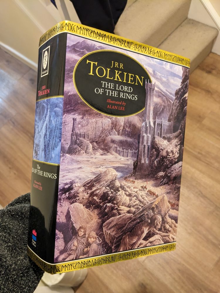 Cover and spine of the 1991 one-volume hardback of The Lord of the Rings (ISBN 0261102303). Alan Lee’s cover image shows Frodo, Sam and Gollum hiding behind rocks as a company of Haradrim march to the Black Gate.