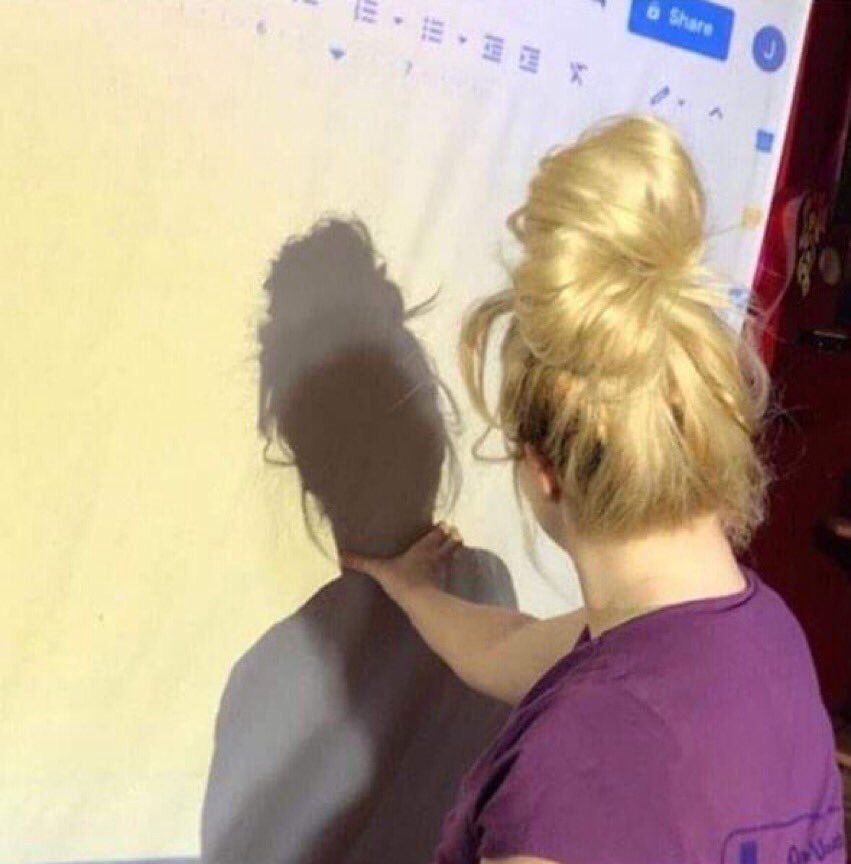 Picture of Trisha Paytas with her hand wrapped around the neck of her shadow. She’s strangling herself in essence. That’s the joke. 
