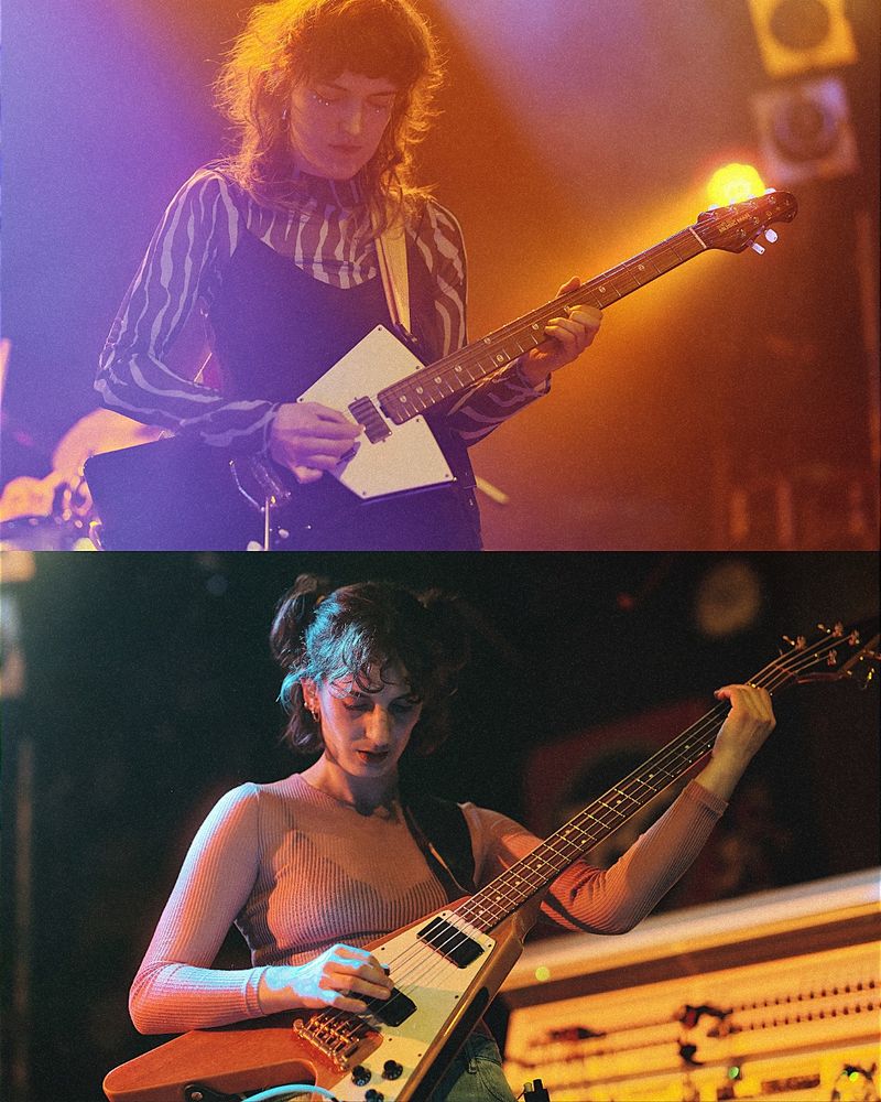 The female bass player and the female guitar player of endless wellness playing their instrument.