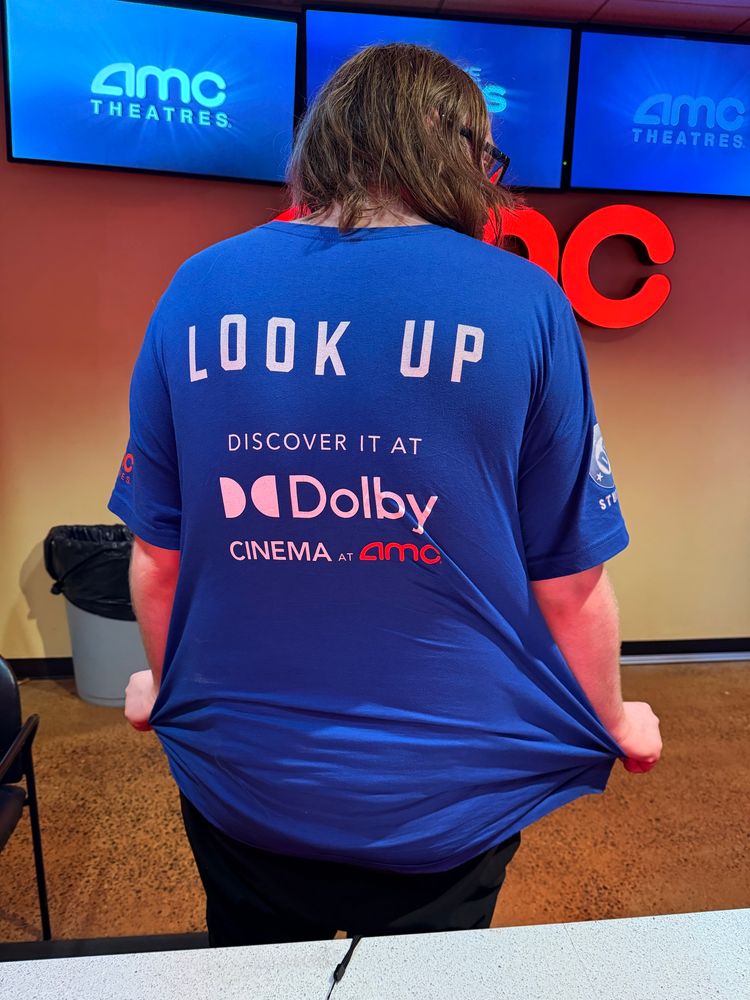 Back of a Superman t-shirt that says Look Up discover it at Dolby cinema at AMC