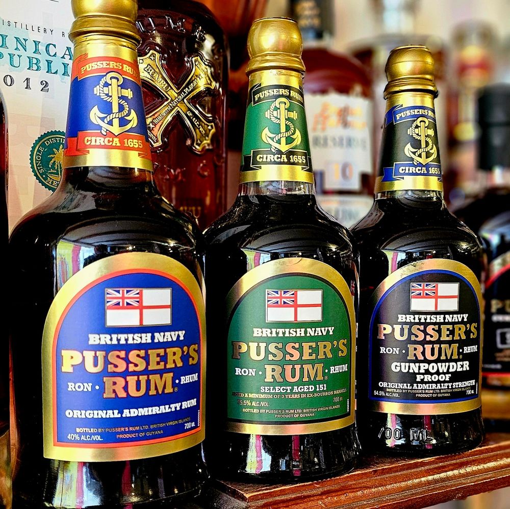 Bottles of Pussers Rum at Fareham Wine Cellar. Left to Right, Blue Label, Select Aged 151 and Gunpowder Proof