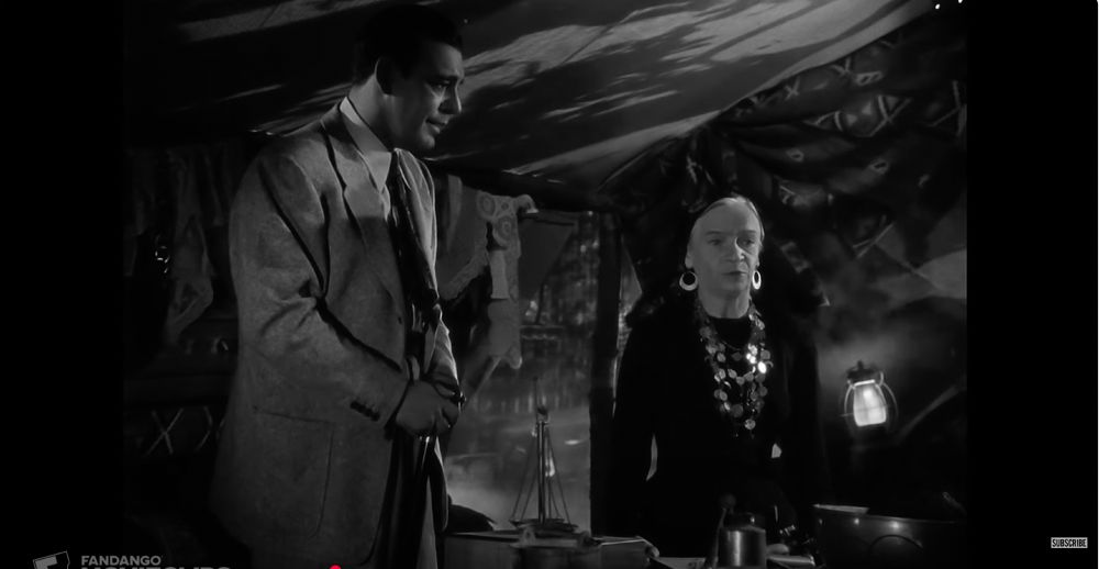 A still from The Wolf Man with Larry getting told how to kill a werewolf by an old gypsy woman