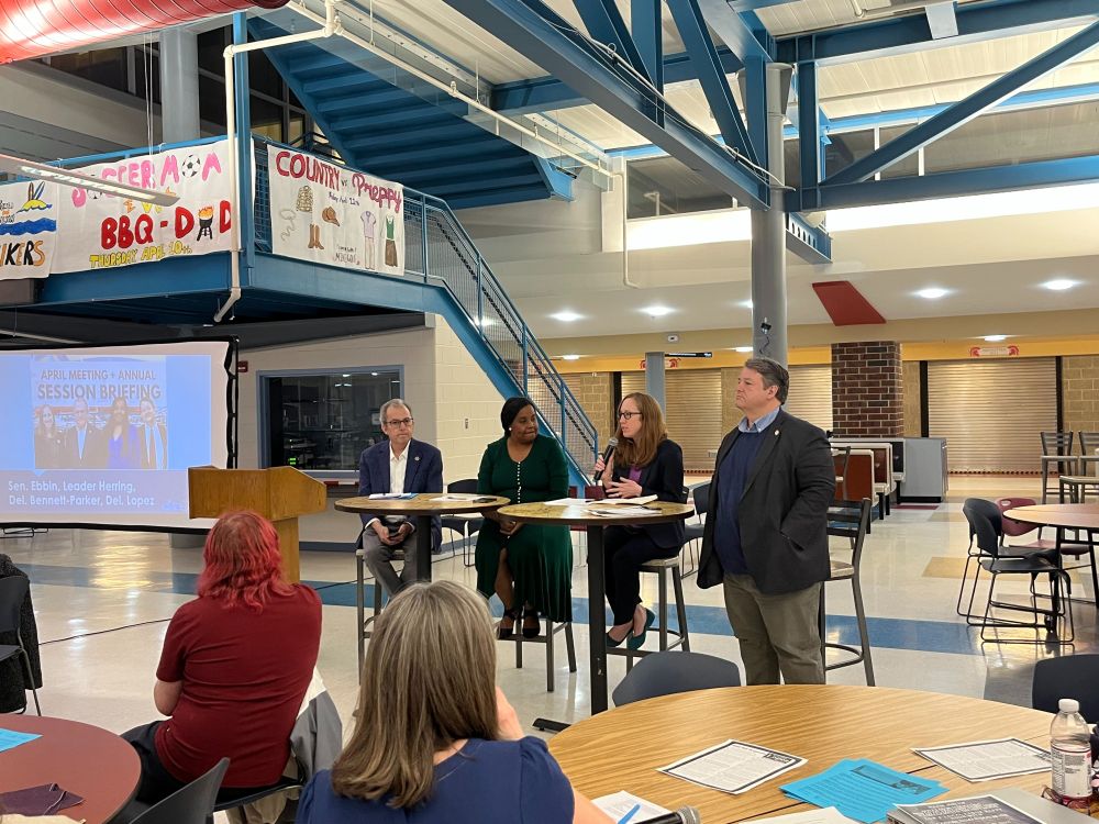 Senator Adam Ebbin, Leader Charniele Herring, Delegate Elizabeth Bennett-Parker seated behind high top tables with Delegate Alfonso Lopez standing