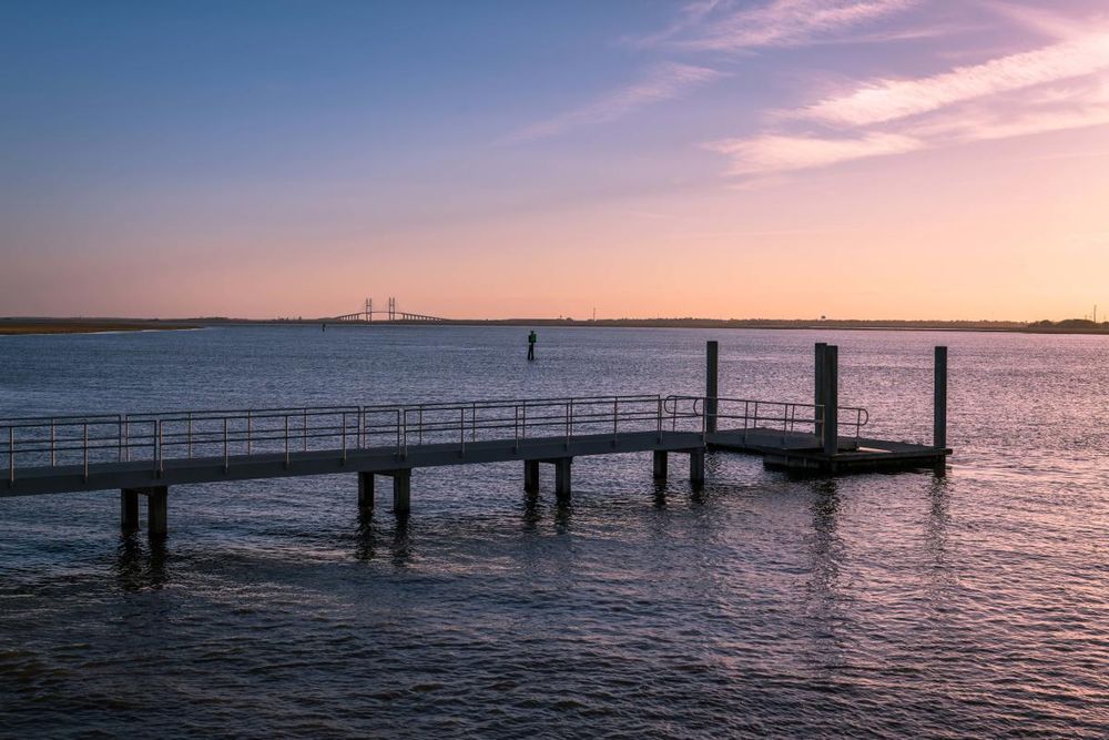 Photo of a fishing pier on the Mackay River at sunset