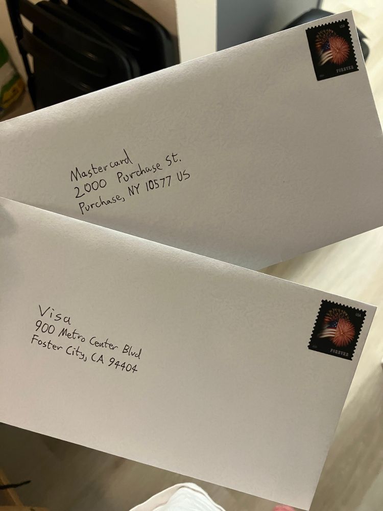 Photo of two letter envelopes addressed to Mastercard and Visa respectively