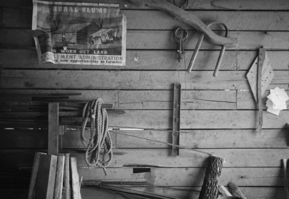 Smithy’s tools: Designed to assist hard-hit tenant farmers to become landowners, the Skyline Farms project in Alabama was a New Deal program of the Resettlement Administration, which became the Farm Security Administration. Ben Shahn photographed the project in 1937. The image shows the wall of a blacksmith shop with various tools. A Resettlement Administration poster on the wall says: "Rural slums on worn out land. Resettlement Administration is offering new opportunities to farmers.”