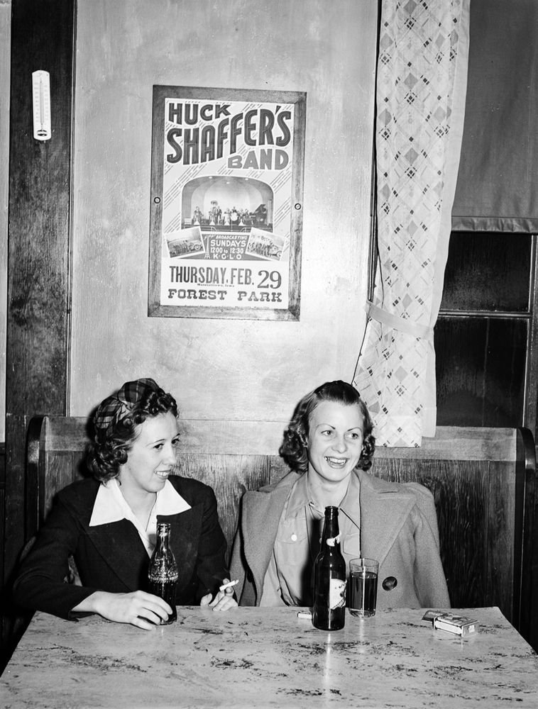 Girls just wanna have fun: In Arthur Rothstein’s photograph, two women sit at a table in a bar in Marshalltown, Iowa, in February 1940. Taking a break from dancing in the adjacent dance hall, they enjoy Coca-Cola, beer and Camels, perhaps planning to attend a performance by Huck Shaffer’s Band at Forest Park.