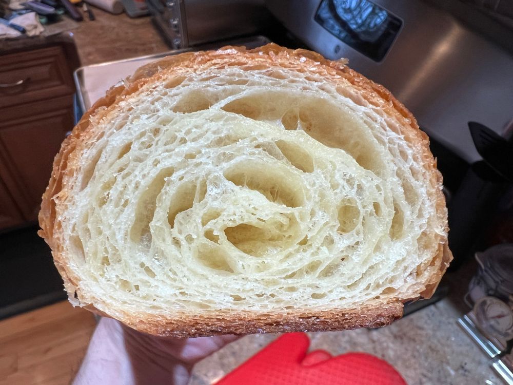A close-up cross section of a croissant showing the gaps between the layers