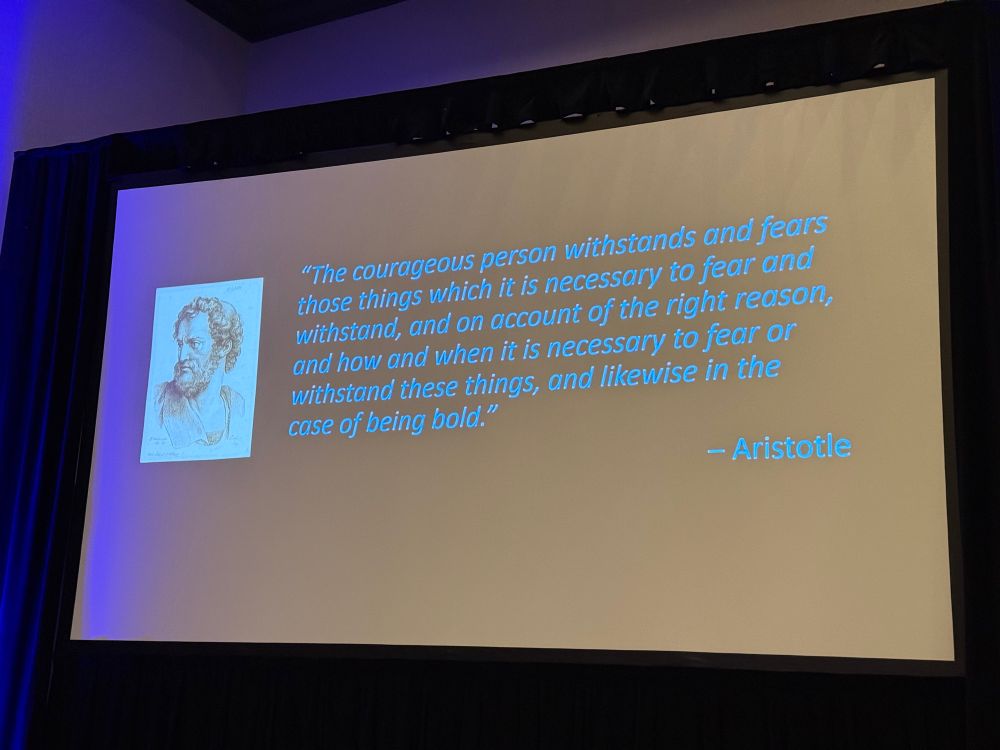 Photo of slide with quote from Aristotle