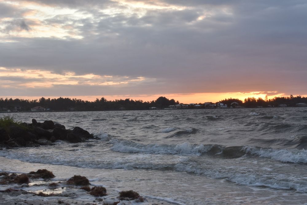 A photograph of a sunset over a beach