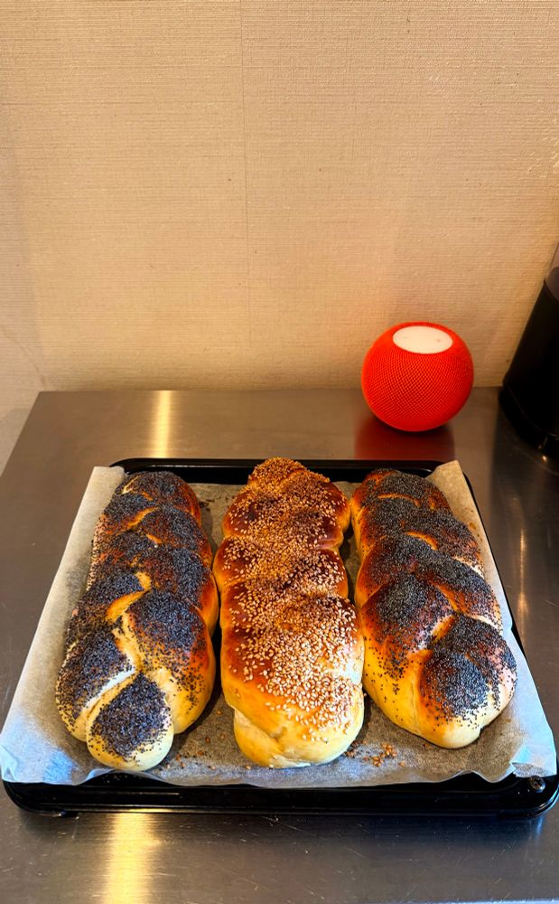 Three small loaves of braided bread fresh out of the oven. 