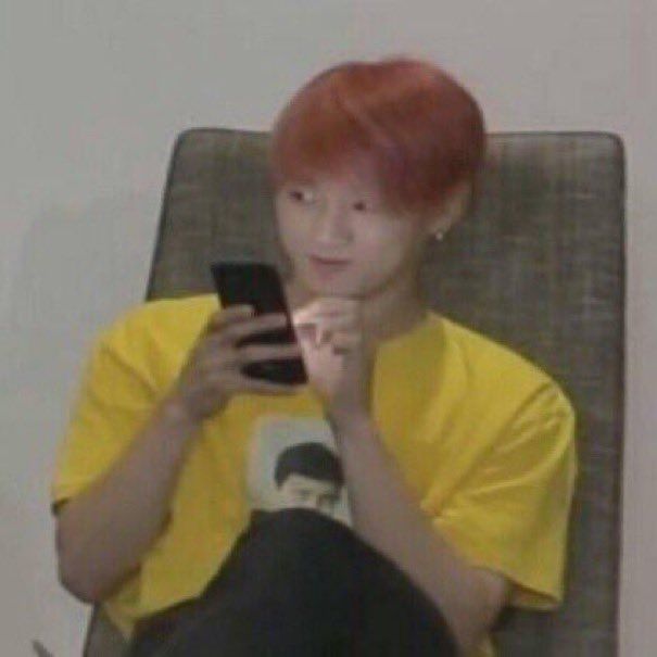 Jungkook holding his phone smirking at J-Hope