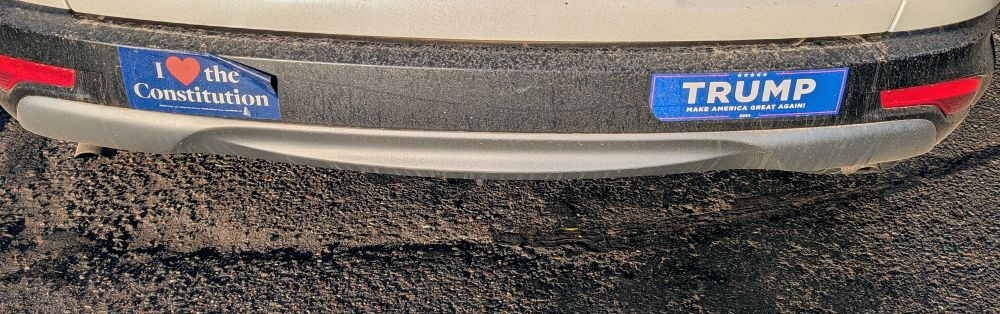 Bumper stickers on the same car: 'i ♥️ the constitution ' and trump 