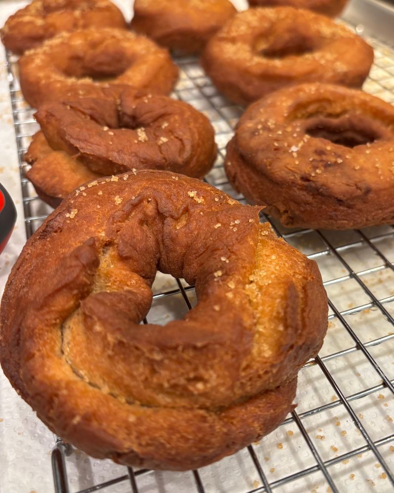 Homemade Apple cider donuts on a cooling rack.