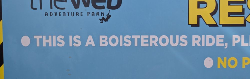A sign for a rollercoaster that reads 'this is a boisterous ride'