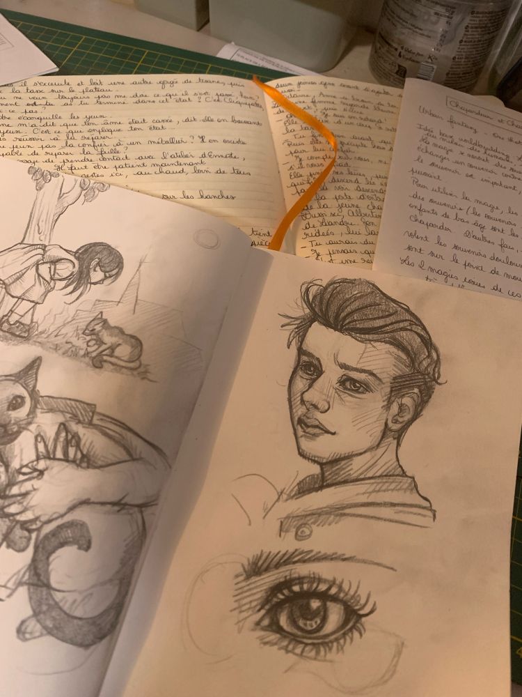 Sketch book and notebook. Sketches of a young man, an female eye and a little girl with her cat