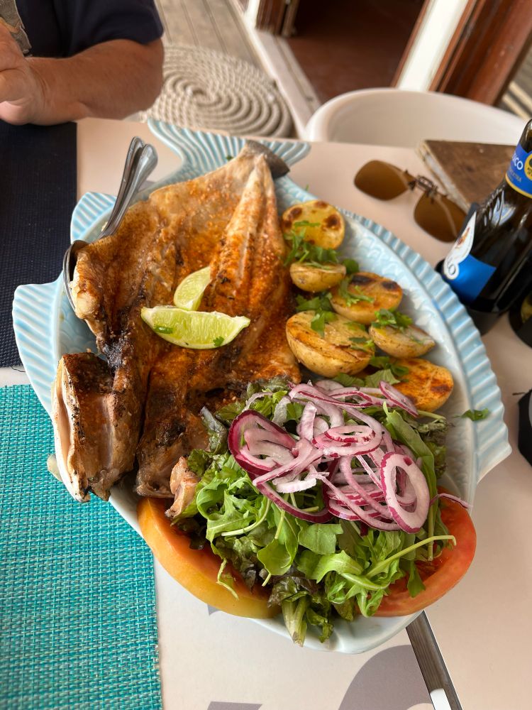 Grilled sea bass (robalo) and accompaniments.
