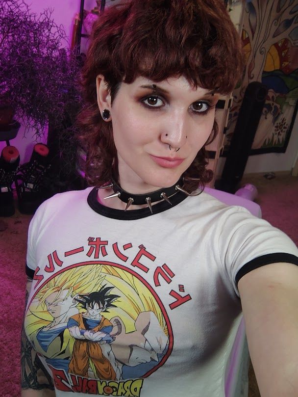 Kodama wearing a very tight dragon ball z crop top and a spiked collar