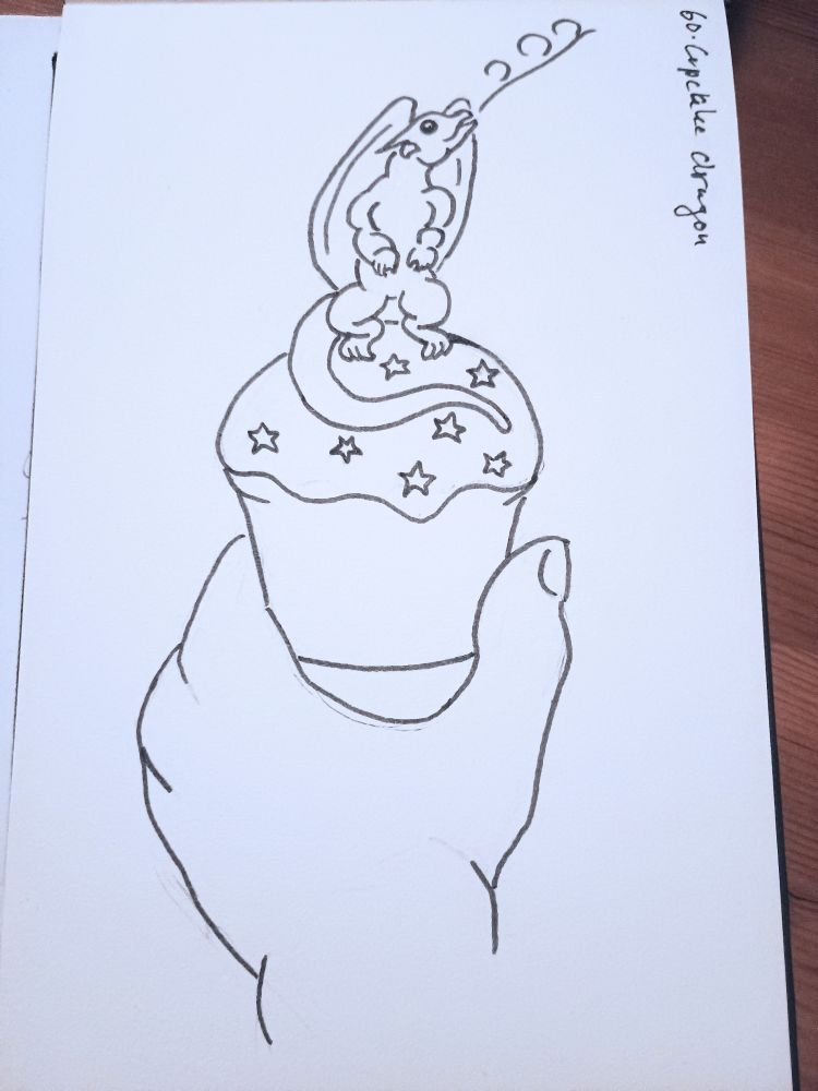 An ink drawing of a hand holding a cupcake, iced with star sprinkles, on which sits a tiny winged dragon, blowing a wisp of flame