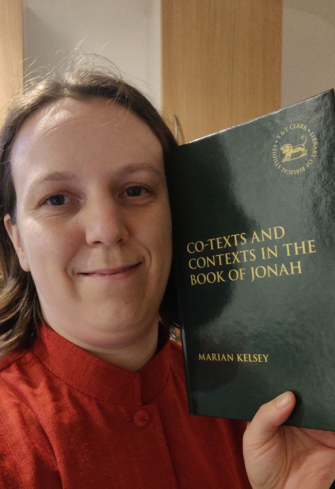 Smiling me holding a copy of my freshly published book "Co-texts and contexts in the book of Jonah"