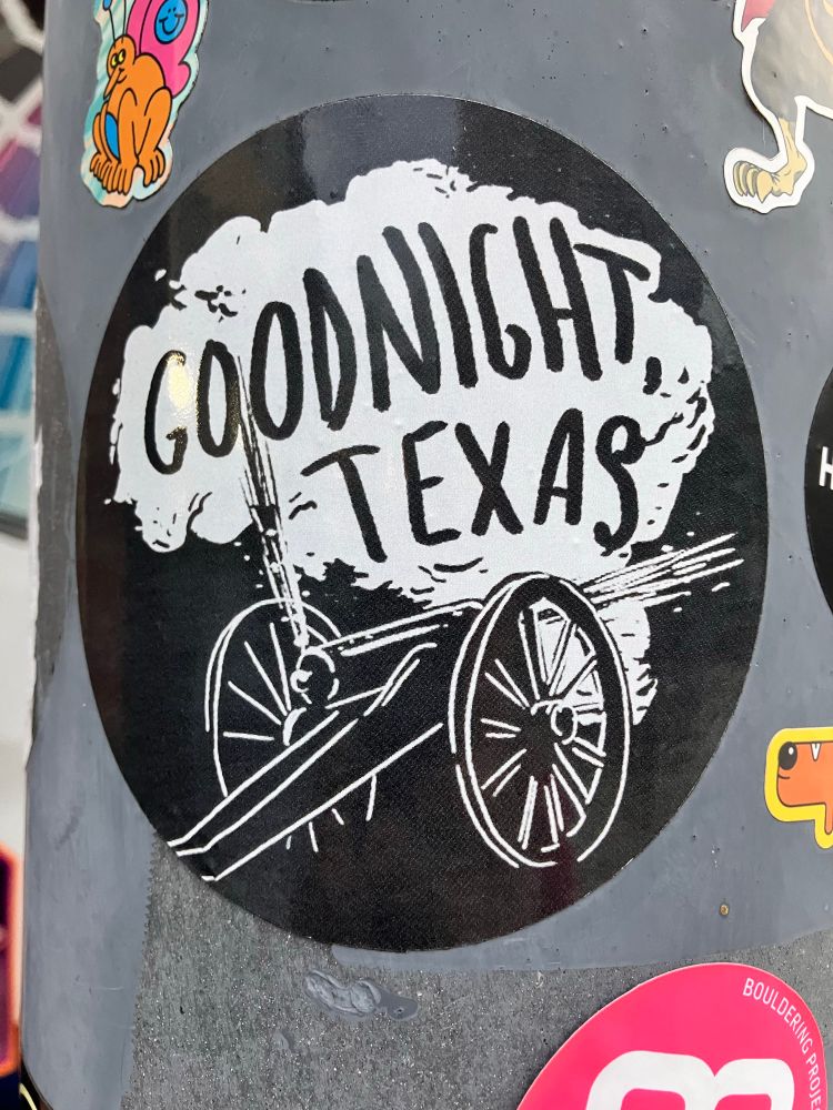 Sticker on a light post that says Goodnight Texas