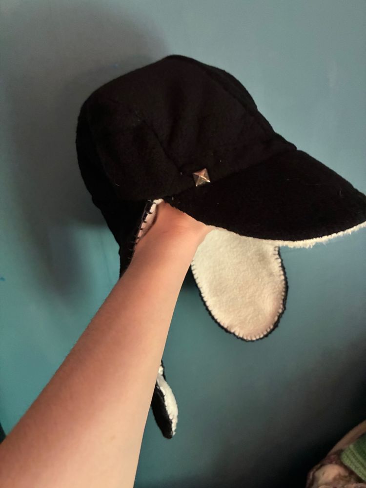 Three-quarters view of hat being held up by me.