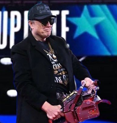 Space cunt holding a chainsaw on a stage at CPAC. 