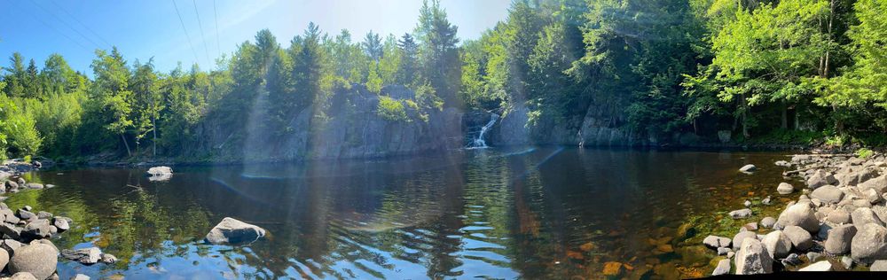 A panorama of the falls. Was lovely warm water to swim in until you got right up to the falls. 