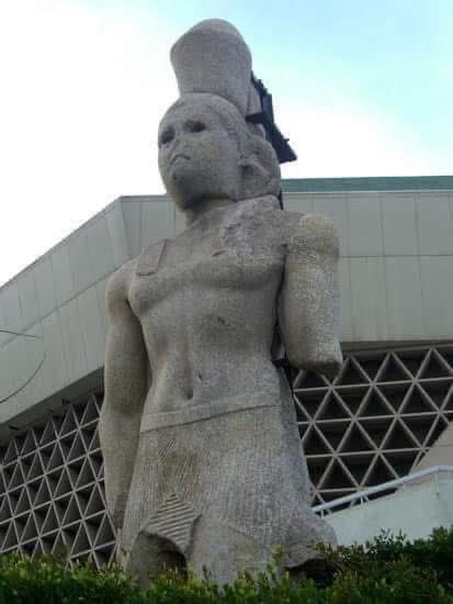 Colossal pink granite statue of a Ptolemaic king, wearing the Double Crown and chendyt kilt, excavated from the Eastern Harbour of Alexandria between 1995-6, now  displayed outside the Bibliotheca Alexandrina. 

