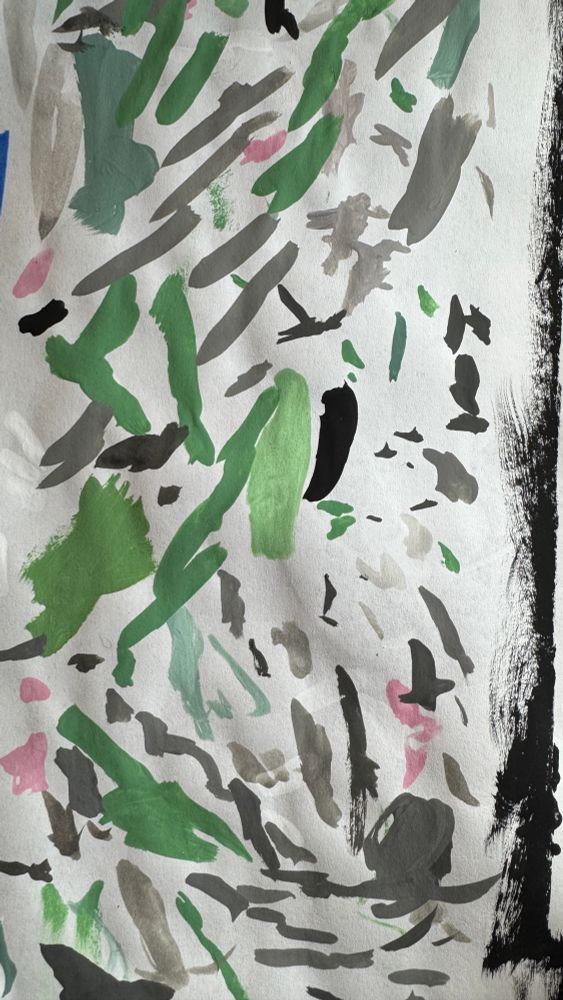 A random smattering of green, gray and pink brush strokes across a white piece of paper.