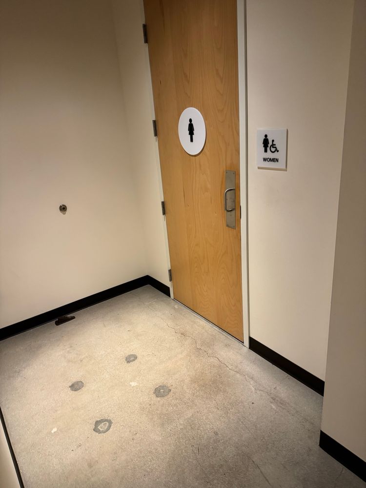 The pristine floor in front of a women’s room door. 