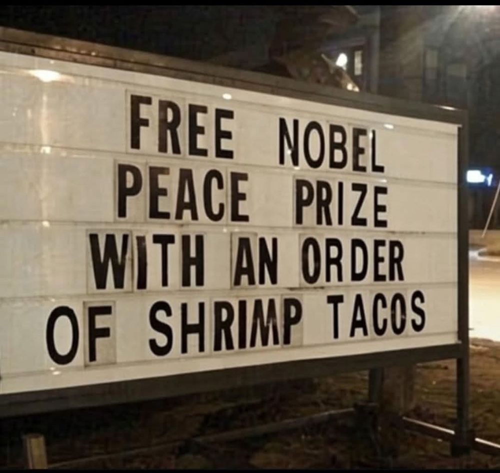 Sign says,  Free Nobel Peace Prize with an order of shrimp tacos. 