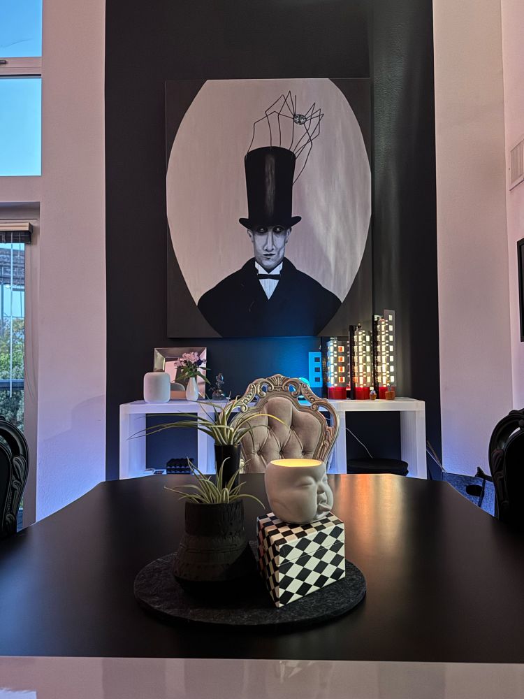 goth inspired tabletop and lit-up sidebar with a painting of a man in top hat that has a spider on top at twilight 