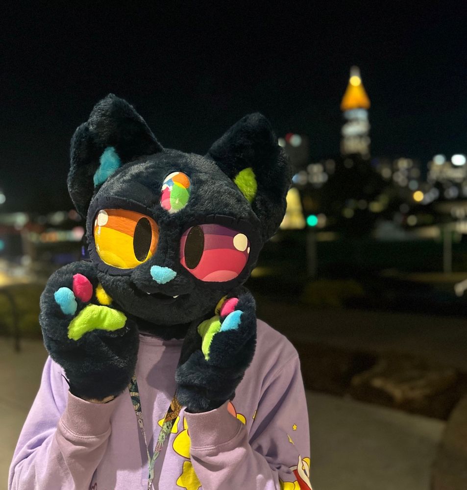 me in mir head and paws in front of atlanta skyline at fwa 2025 :)